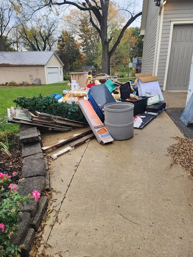 Dumpster being loaded with debris for Residential Dumpster Rental in Rose Hill
